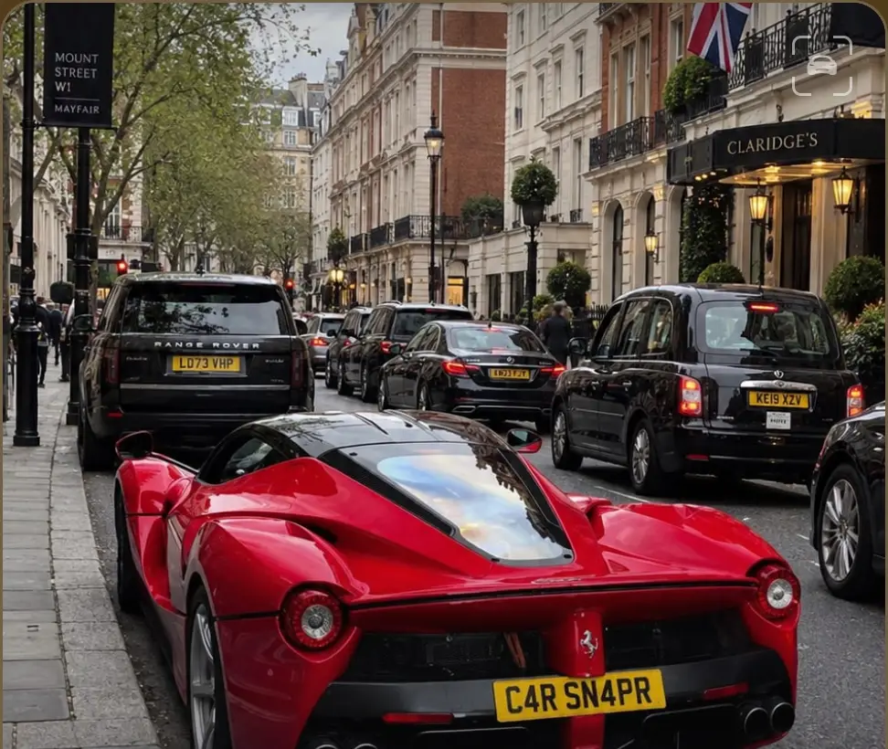 A red Ferrari LaFerrari on a London street, being scanned.